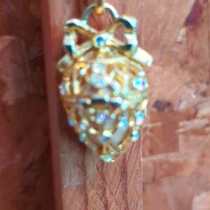 Joan Rivers gold necklace with filagre egg